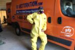 911 Restoration technician in Hazmat suit